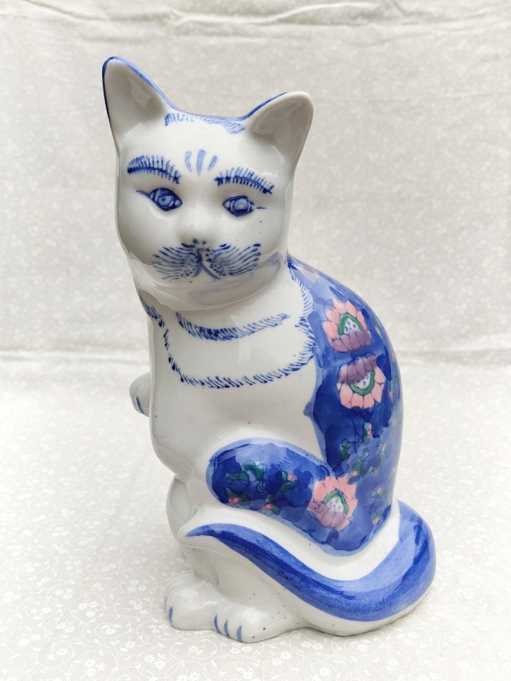 Iso istuva keramiikkakissa.